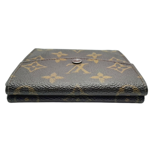 409 - A Louis Vuitton Monogram Canvas Wallet. Brown monogram canvas exterior with a press-stud closure. Do... 