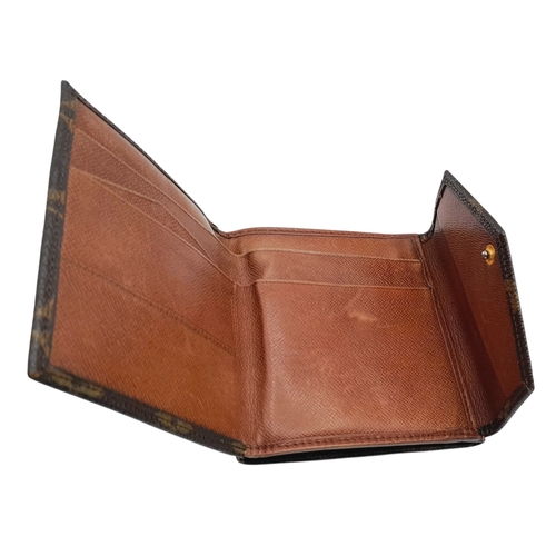 409 - A Louis Vuitton Monogram Canvas Wallet. Brown monogram canvas exterior with a press-stud closure. Do... 