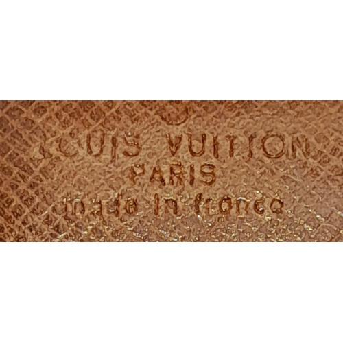 409 - A Louis Vuitton Monogram Canvas Wallet. Brown monogram canvas exterior with a press-stud closure. Do... 