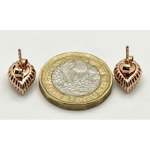 128 - A Pair of 14K Rose Gold Citrine and Diamond Stud Earrings - Both having a 2ct pear cut citrine with ... 