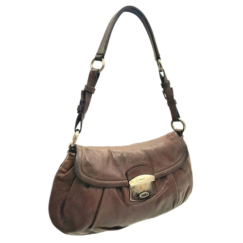 366 - A Prada Hobo Shoulder Bag. Crafted in brown grained leather with silver-tone hardware and an adjusta... 