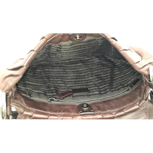 366 - A Prada Hobo Shoulder Bag. Crafted in brown grained leather with silver-tone hardware and an adjusta... 
