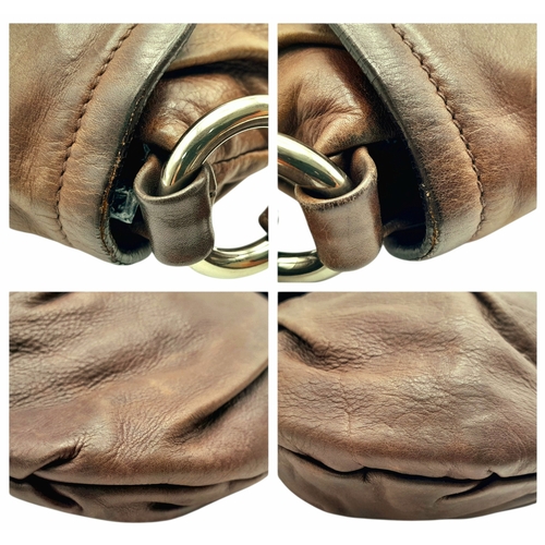 366 - A Prada Hobo Shoulder Bag. Crafted in brown grained leather with silver-tone hardware and an adjusta... 