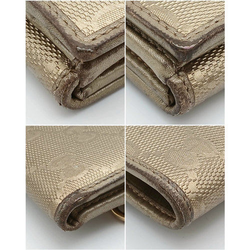 395 - A Gucci Gold GG Canvas Trifold Wallet. Crafted in gold-tone GG monogram canvas with leather trim and... 
