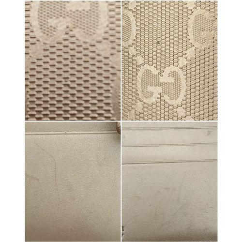 395 - A Gucci Gold GG Canvas Trifold Wallet. Crafted in gold-tone GG monogram canvas with leather trim and... 