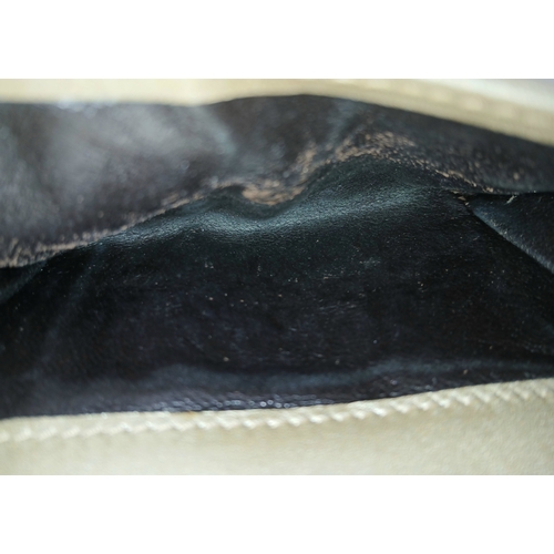 395 - A Gucci Gold GG Canvas Trifold Wallet. Crafted in gold-tone GG monogram canvas with leather trim and... 