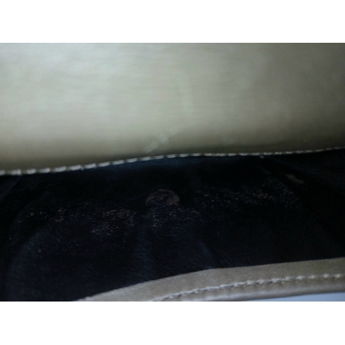 395 - A Gucci Gold GG Canvas Trifold Wallet. Crafted in gold-tone GG monogram canvas with leather trim and... 