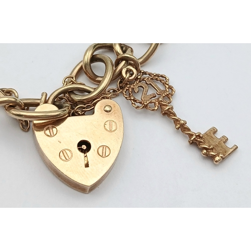 4 - A VINTAGE 9K GOLD BRACELET WITH A HEART SHAPED PADLOCK AND DANGLING KEY CHARM .      16.2gms     19c... 