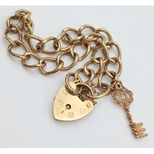4 - A VINTAGE 9K GOLD BRACELET WITH A HEART SHAPED PADLOCK AND DANGLING KEY CHARM .      16.2gms     19c... 