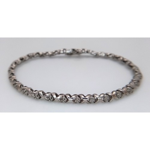 198 - A 9k white gold diamond set bracelet, 0.15ct diamond weight, 6.2g total weight, 18cm total length. R... 