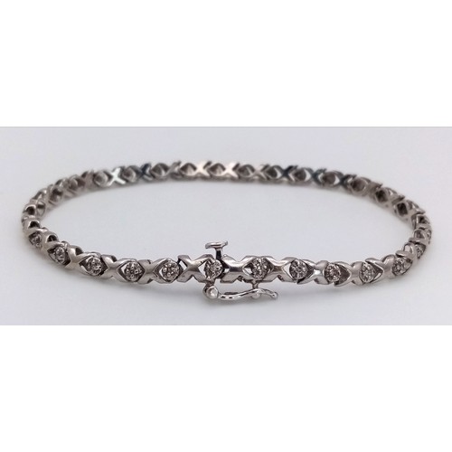 198 - A 9k white gold diamond set bracelet, 0.15ct diamond weight, 6.2g total weight, 18cm total length. R... 