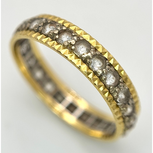 291 - AN 18K GOLD AND DIAMOND FULL ETERNITY RING .     3.4gms        size S