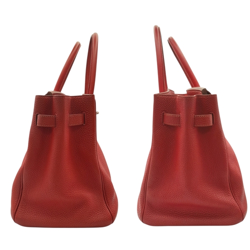 60 - A Red Hermès Birkin 35 Handbag. Red leather exterior with silver-toned hardware, dual rolled leather... 