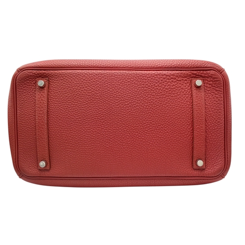 60 - A Red Hermès Birkin 35 Handbag. Red leather exterior with silver-toned hardware, dual rolled leather... 