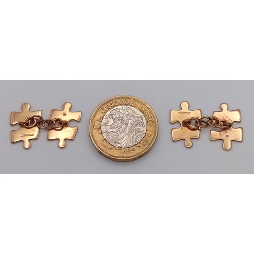 374 - A PAIR OF JIGSAW SHAPED CHAIN LINKED CUFFLINKS IN 9K GOLD .      4.5gms