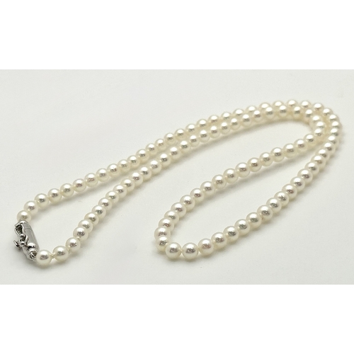 482 - A Platinum and Cultured Pearl Necklace. 2/3mm pearls. 38cm length. 9.3g. MT11.