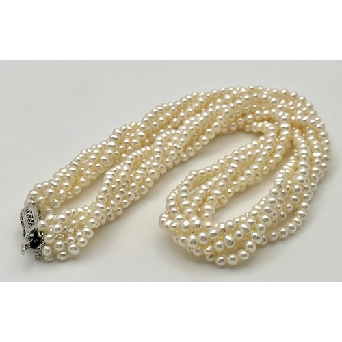 489 - A Silver and Six Strand Freshwater Pearl Necklace. 40cm. 43g. MT10.