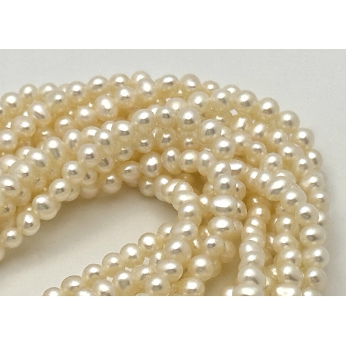 489 - A Silver and Six Strand Freshwater Pearl Necklace. 40cm. 43g. MT10.