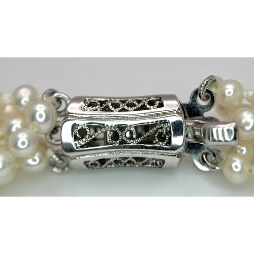 489 - A Silver and Six Strand Freshwater Pearl Necklace. 40cm. 43g. MT10.