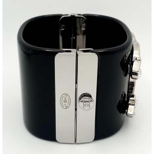 125 - A Chanel Black CC Embellished Cuff Bangle. Set with white stones. 5.5cm width. 58mm inner diameter. ... 