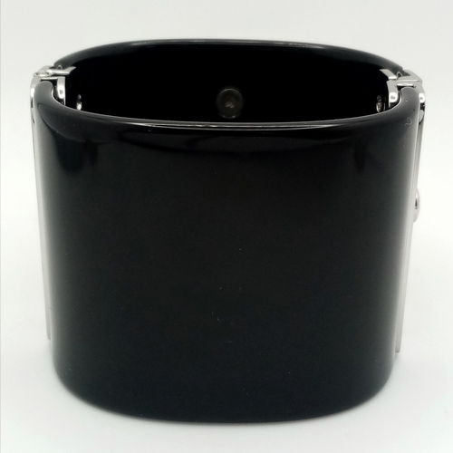 125 - A Chanel Black CC Embellished Cuff Bangle. Set with white stones. 5.5cm width. 58mm inner diameter. ... 