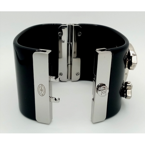 125 - A Chanel Black CC Embellished Cuff Bangle. Set with white stones. 5.5cm width. 58mm inner diameter. ... 