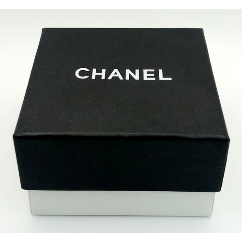 125 - A Chanel Black CC Embellished Cuff Bangle. Set with white stones. 5.5cm width. 58mm inner diameter. ... 