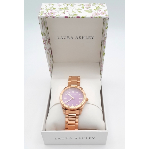 1001 - A LAURA ASHLEY, ROSE GOLD TONE, LILAC DIAL, BRACELET WATCH. IN FULL WORKING ORDER, AS NEW, IN ORIGIN... 
