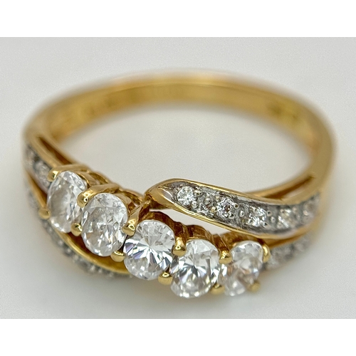 319 - A 14K Yellow Gold White Zircon Crossover Ring. Bright stones. Size Q. 3.25g. Ref: 639121