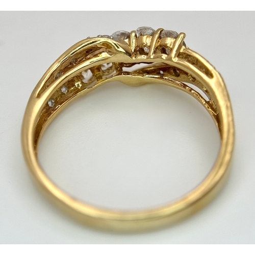 319 - A 14K Yellow Gold White Zircon Crossover Ring. Bright stones. Size Q. 3.25g. Ref: 639121