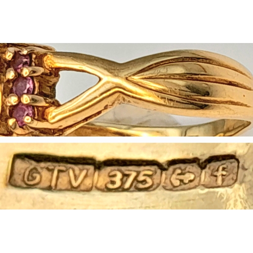 175 - A 9K Yellow Gold Garnet Ring. A cushion cut garnet c.2ct sits on a raised setting with garnet accent... 