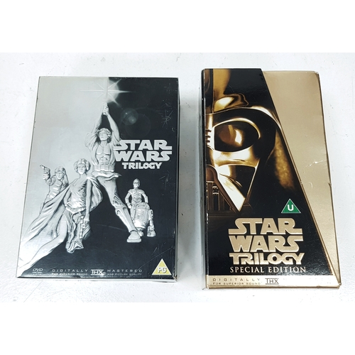 81 - A bundle of Star Wars collectables. To include three framed posters, VHS videos, DVD's, figures and ... 
