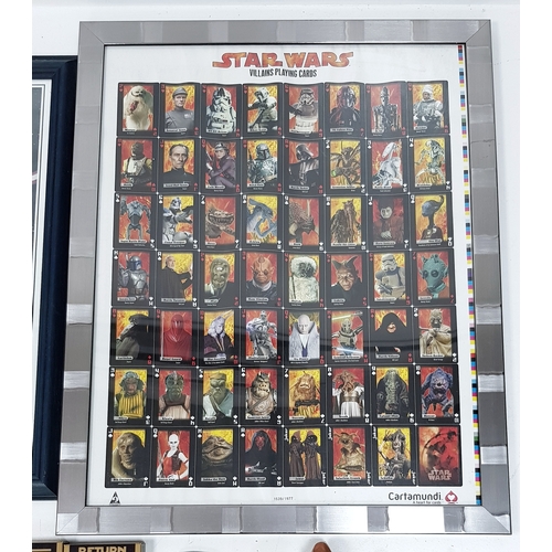 81 - A bundle of Star Wars collectables. To include three framed posters, VHS videos, DVD's, figures and ... 