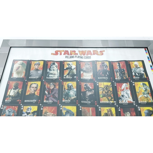 81 - A bundle of Star Wars collectables. To include three framed posters, VHS videos, DVD's, figures and ... 