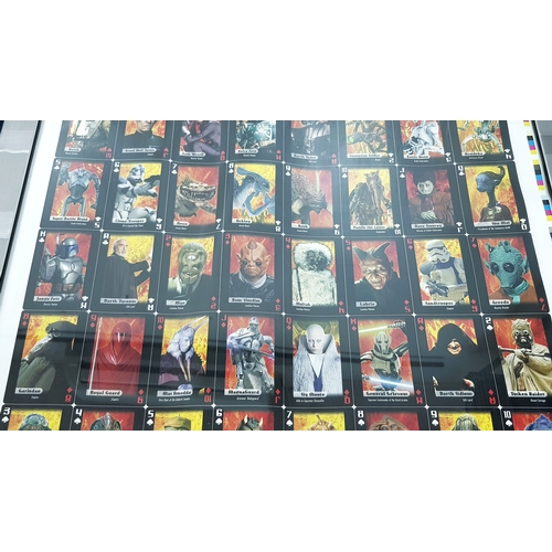 81 - A bundle of Star Wars collectables. To include three framed posters, VHS videos, DVD's, figures and ... 