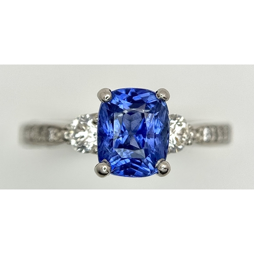 113 - A Dazzling 950 Platinum Sapphire and Diamond Ring. A 1.75ct cushion mixed cut sapphire with thirty-f... 