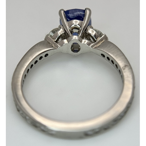 113 - A Dazzling 950 Platinum Sapphire and Diamond Ring. A 1.75ct cushion mixed cut sapphire with thirty-f... 