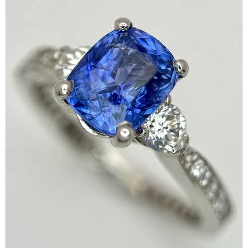 113 - A Dazzling 950 Platinum Sapphire and Diamond Ring. A 1.75ct cushion mixed cut sapphire with thirty-f... 