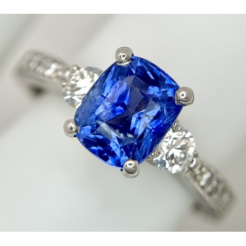 113 - A Dazzling 950 Platinum Sapphire and Diamond Ring. A 1.75ct cushion mixed cut sapphire with thirty-f... 