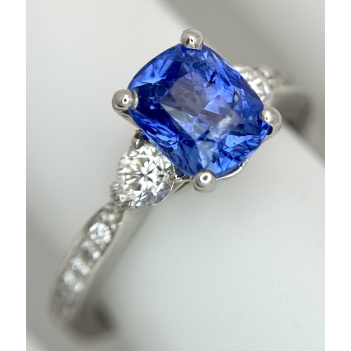 113 - A Dazzling 950 Platinum Sapphire and Diamond Ring. A 1.75ct cushion mixed cut sapphire with thirty-f... 