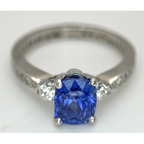 113 - A Dazzling 950 Platinum Sapphire and Diamond Ring. A 1.75ct cushion mixed cut sapphire with thirty-f... 