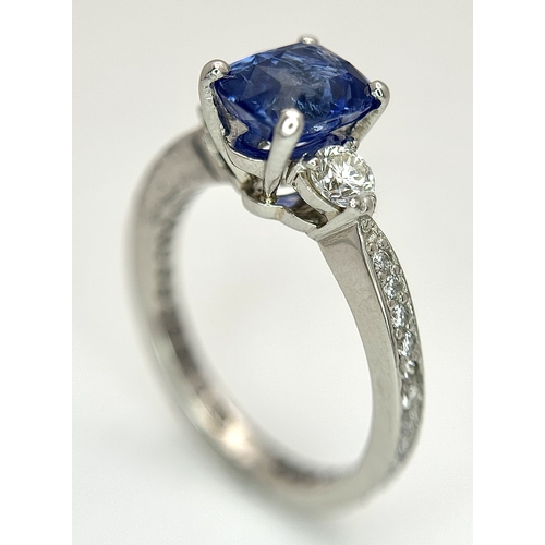 113 - A Dazzling 950 Platinum Sapphire and Diamond Ring. A 1.75ct cushion mixed cut sapphire with thirty-f... 