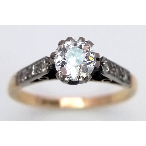 687 - An 18K Yellow Gold Diamond Ring. 0.65ct old European cut centre diamond. Additional diamonds to shou... 