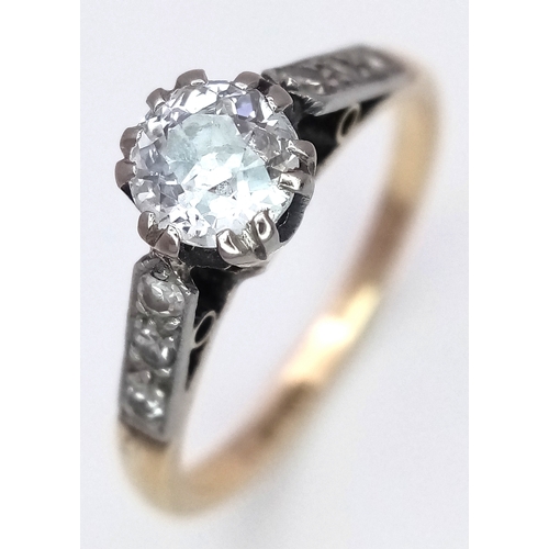 687 - An 18K Yellow Gold Diamond Ring. 0.65ct old European cut centre diamond. Additional diamonds to shou... 