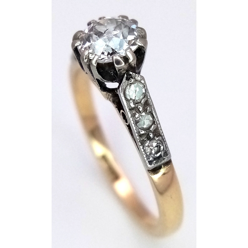 687 - An 18K Yellow Gold Diamond Ring. 0.65ct old European cut centre diamond. Additional diamonds to shou... 