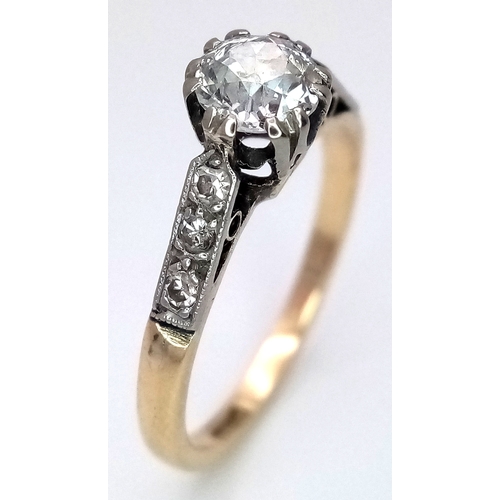 687 - An 18K Yellow Gold Diamond Ring. 0.65ct old European cut centre diamond. Additional diamonds to shou... 