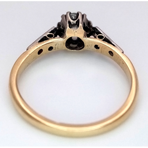687 - An 18K Yellow Gold Diamond Ring. 0.65ct old European cut centre diamond. Additional diamonds to shou... 