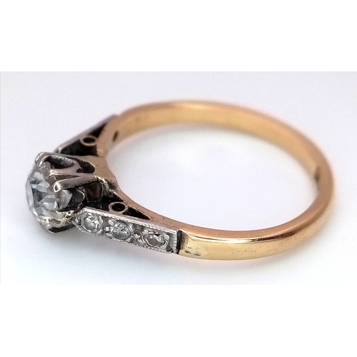 687 - An 18K Yellow Gold Diamond Ring. 0.65ct old European cut centre diamond. Additional diamonds to shou... 