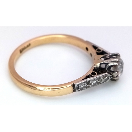 687 - An 18K Yellow Gold Diamond Ring. 0.65ct old European cut centre diamond. Additional diamonds to shou... 