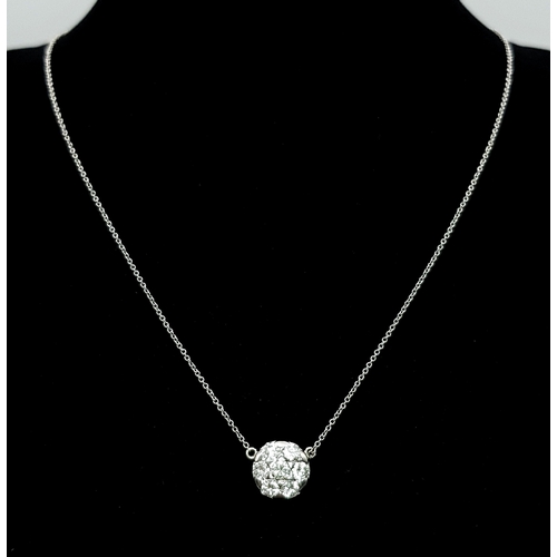 90 - An 18K White Gold and Diamond Circular Lavaliere Pendant on an 18K White Gold Chain. c 1.2ctw of rou... 